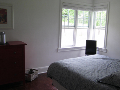 Master bedroom with a serene woodland view